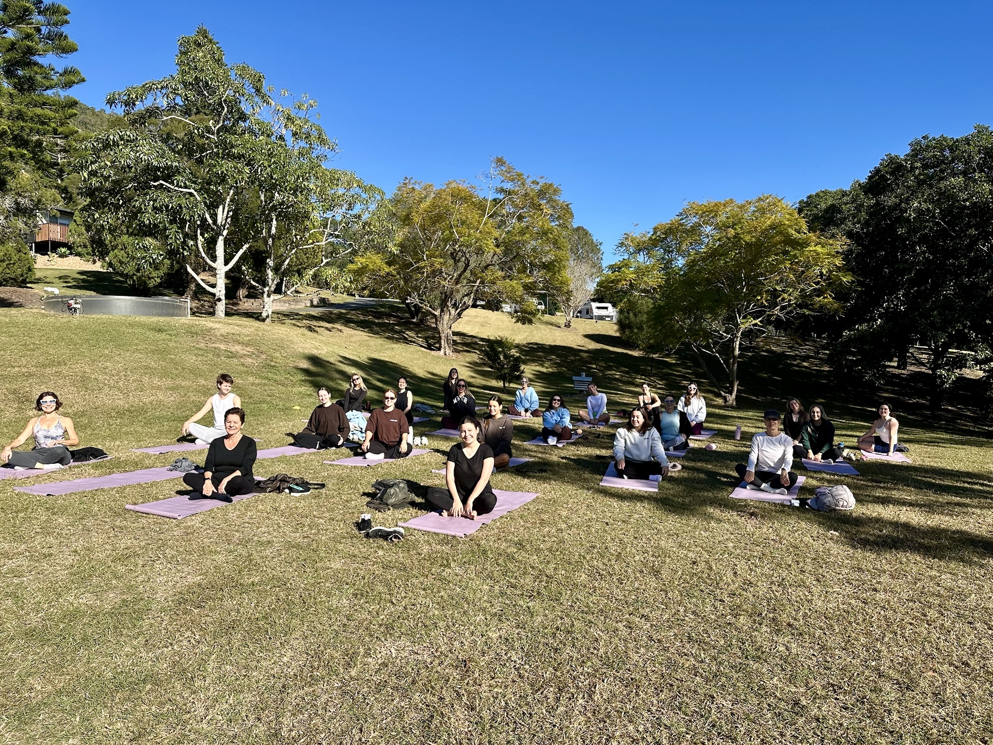 A group yoga session on the lawn at The Archer Retreat
