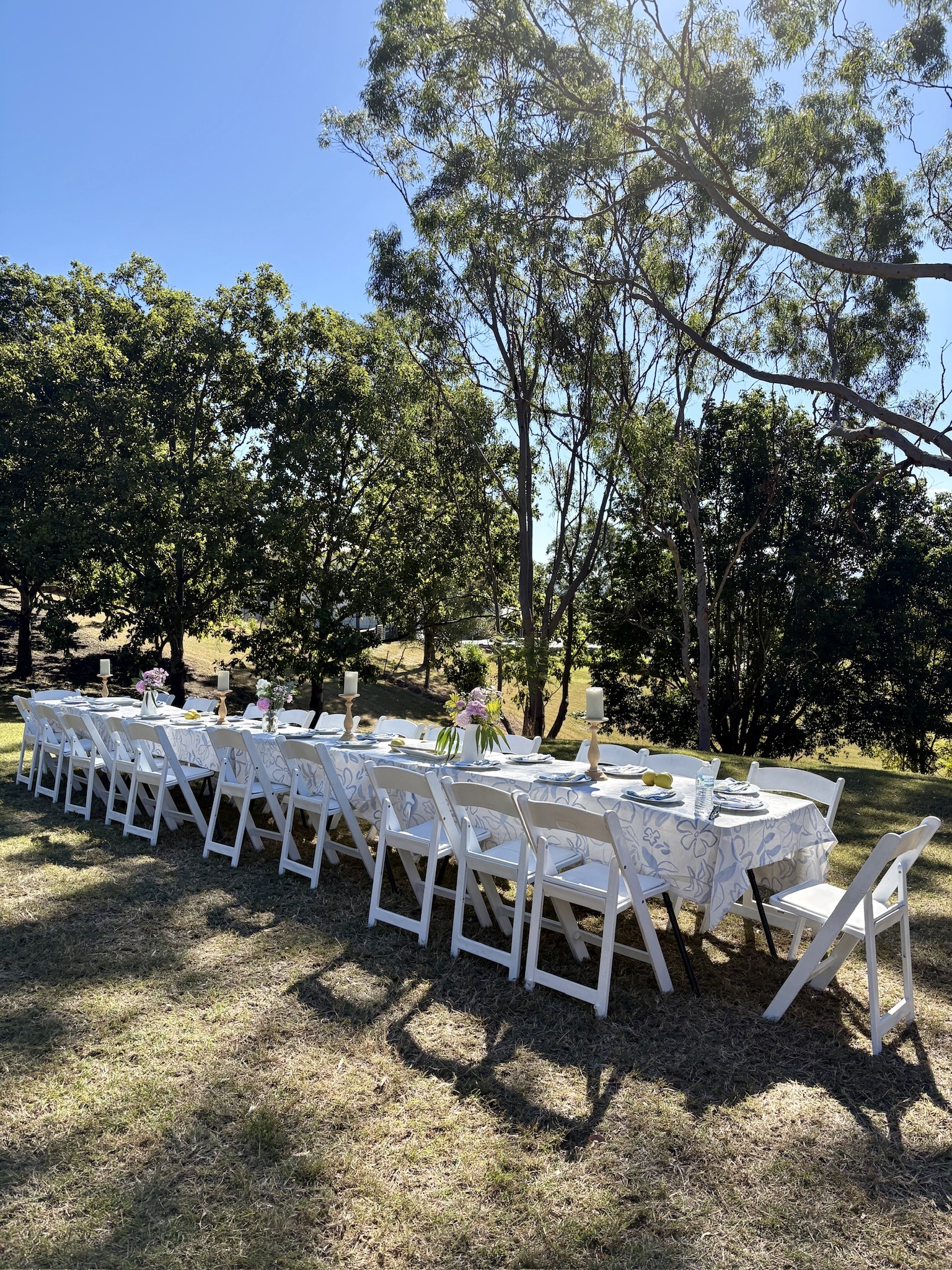 Outdoor celebration table set beneath trees at The Archer Retreat